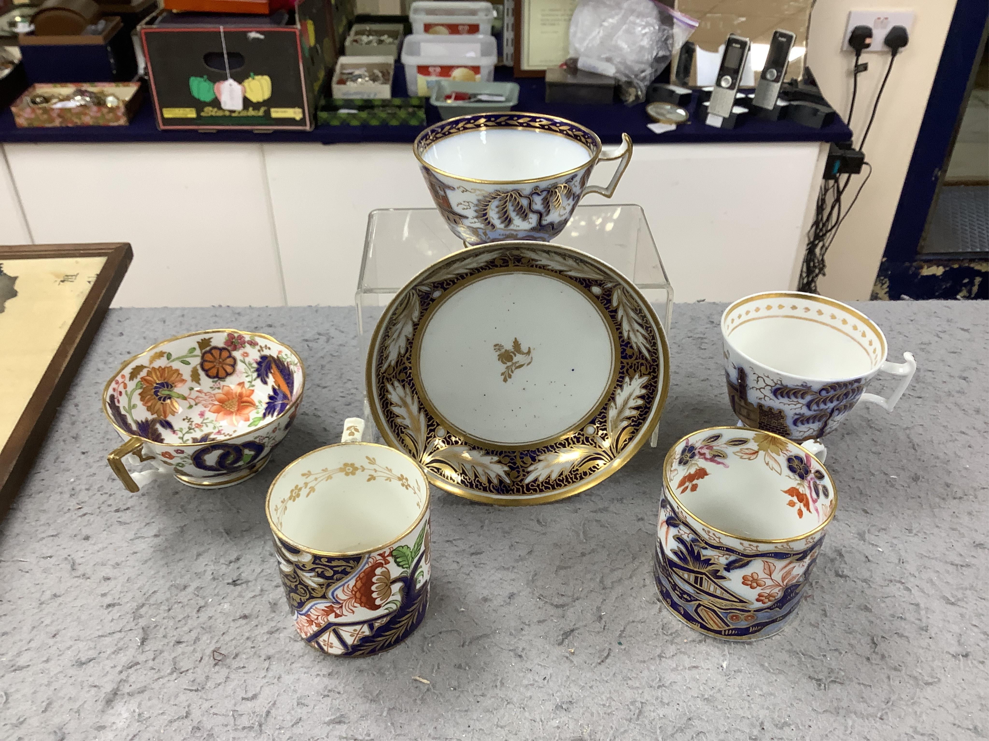 Eleven 1800-1820 English porcelain coffee cans and tea cups, including Imari pattern examples, one with matching saucer